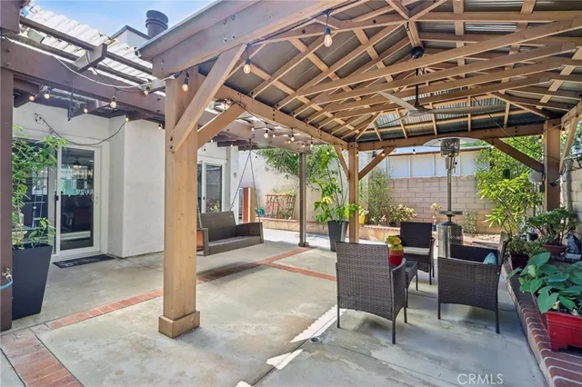 a building outdoor space with patio furniture and potted plants