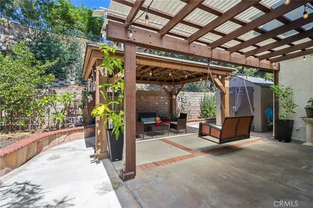 a view of a patio with table and chairs potted plants with floor to ceiling window and potted plants