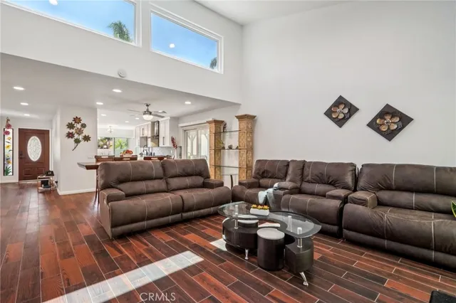 a living room with furniture and a wooden floor