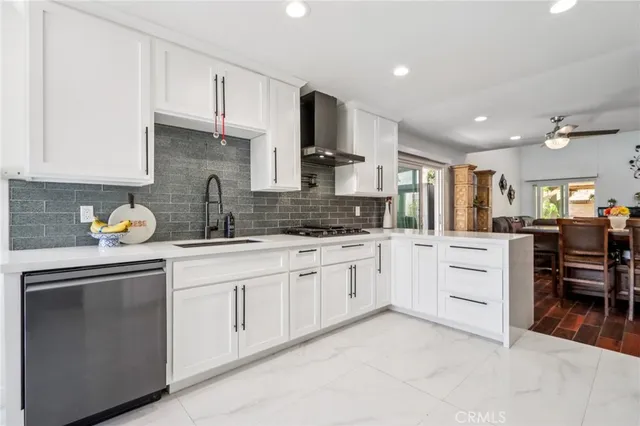 a kitchen with white cabinets and appliances