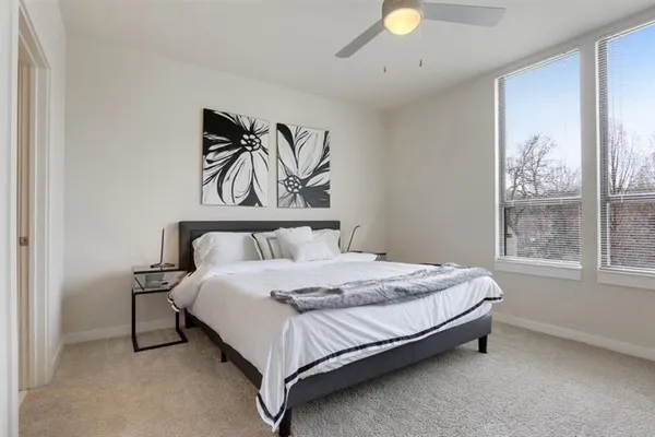 a bed sitting in a bedroom next to a window