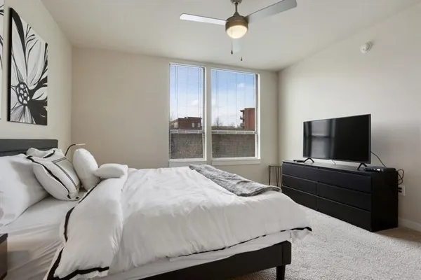 a bedroom with a bed and a flat screen tv