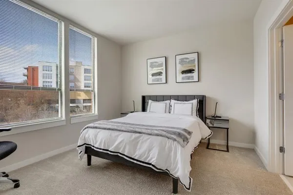 a bed sitting in a bedroom next to a window