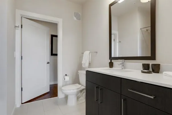 a bathroom with a toilet sink and mirror