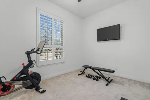 a view of a room with gym equipment and a window