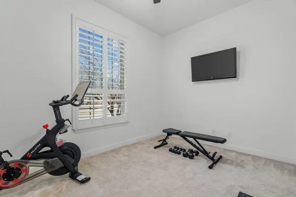 a view of a room with gym equipment and a window