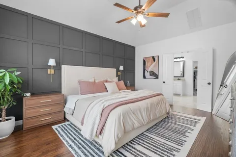 a bedroom with bed and wooden floor