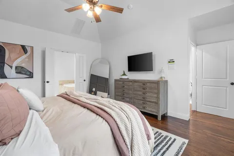 a bedroom with a bed and a flat screen tv