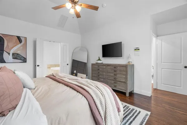 a bedroom with a bed and a flat screen tv