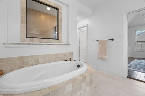 a white bath tub sitting next to a bathroom sink