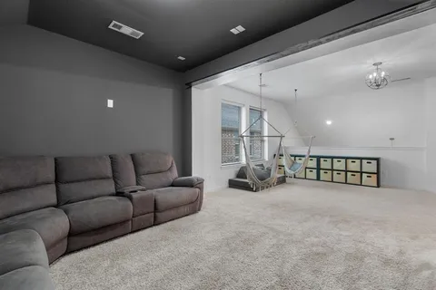 a living room with furniture and a ceiling fan