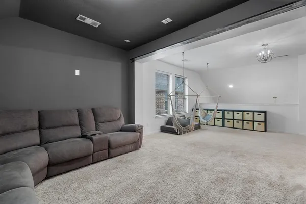a living room with furniture and a ceiling fan