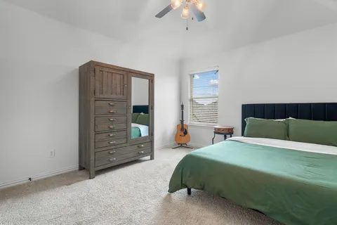 a bedroom with a bed and a dresser