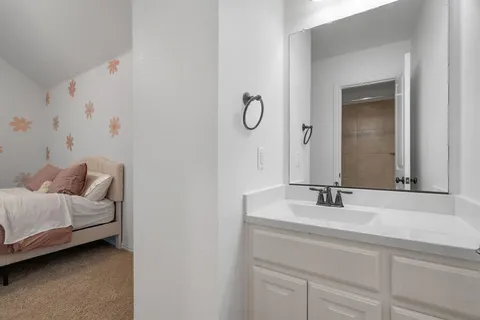 a bathroom with a double vanity sink and mirror