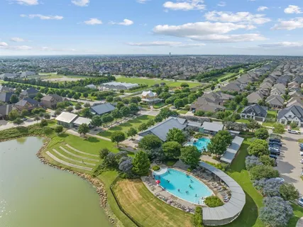 a view of a swimming pool with a lot of trees & houses