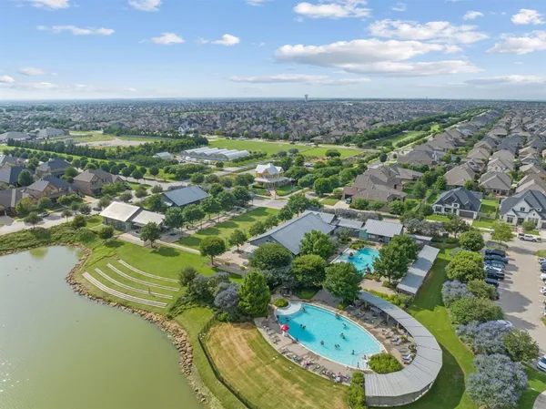 a view of a swimming pool with a lot of trees & houses