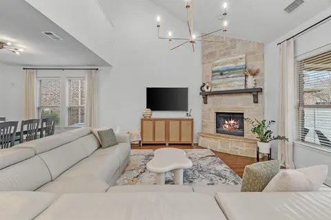 a living room with furniture a fireplace and a flat screen tv