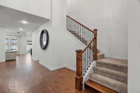 a view of entryway and hall with wooden floor