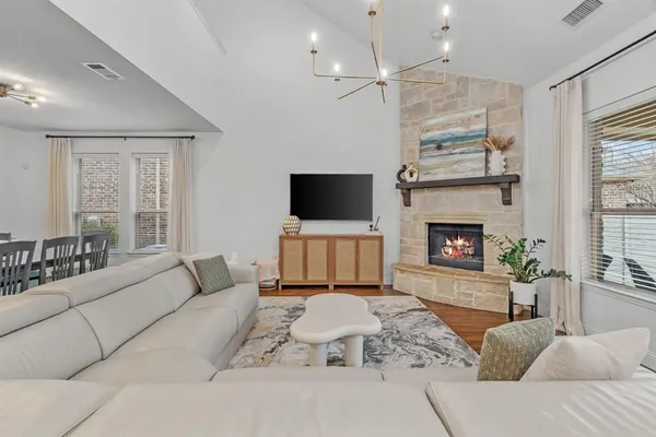 a living room with furniture a fireplace and a flat screen tv