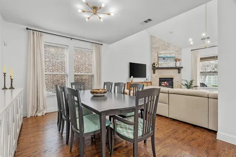 a dining room with furniture and wooden floor