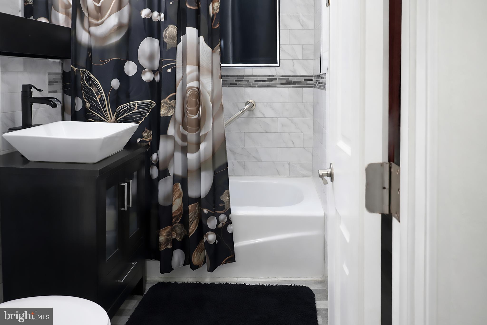 3935 Clay Place Northeast Washington, DC 20019 - Photo 10 of 17 a bathroom with a granite countertop sink a toilet and bathtub