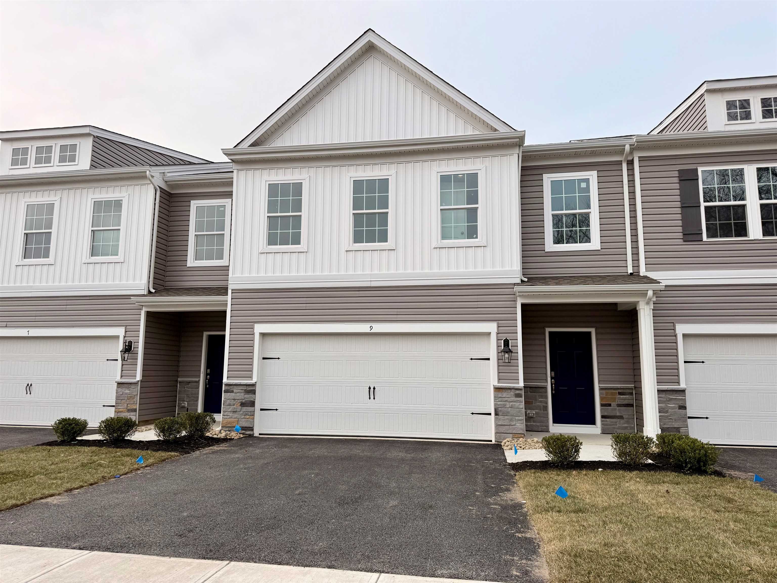 a front view of a house with a yard and garage