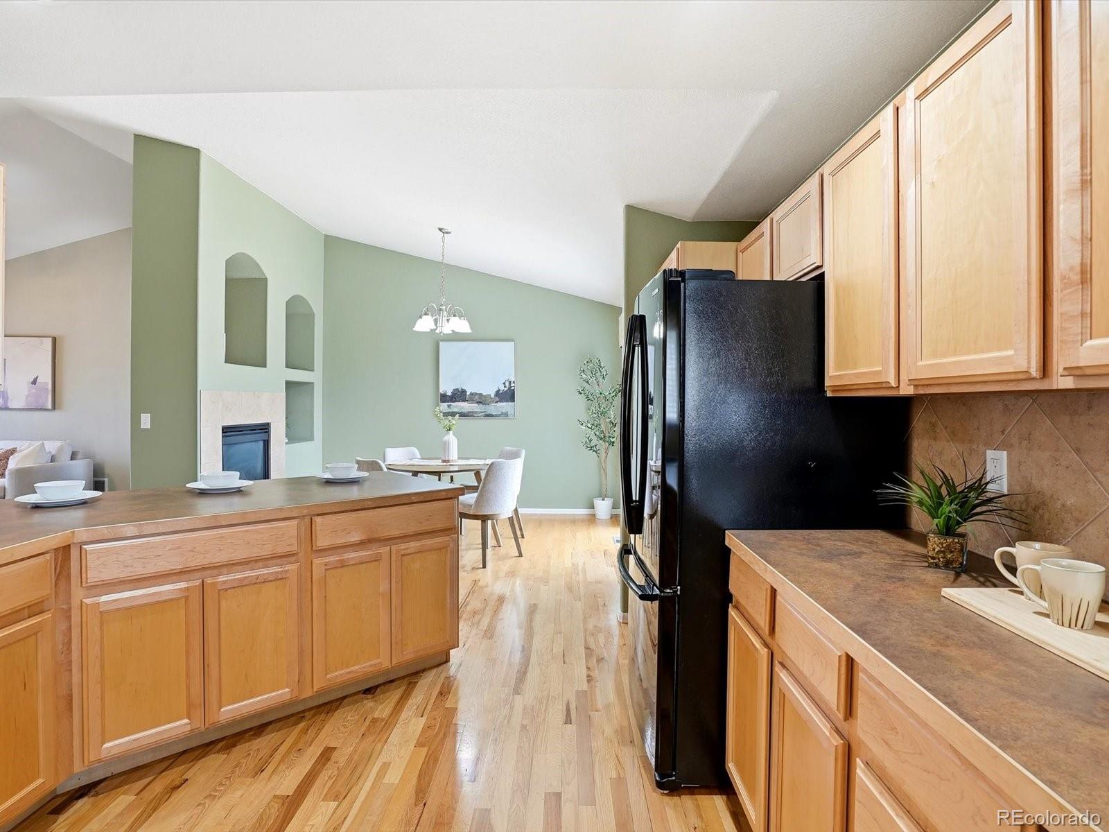 9720 Roadrunner Avenue Firestone, CO 80504 - Photo 12 of 46 a kitchen with a sink refrigerator and cabinets