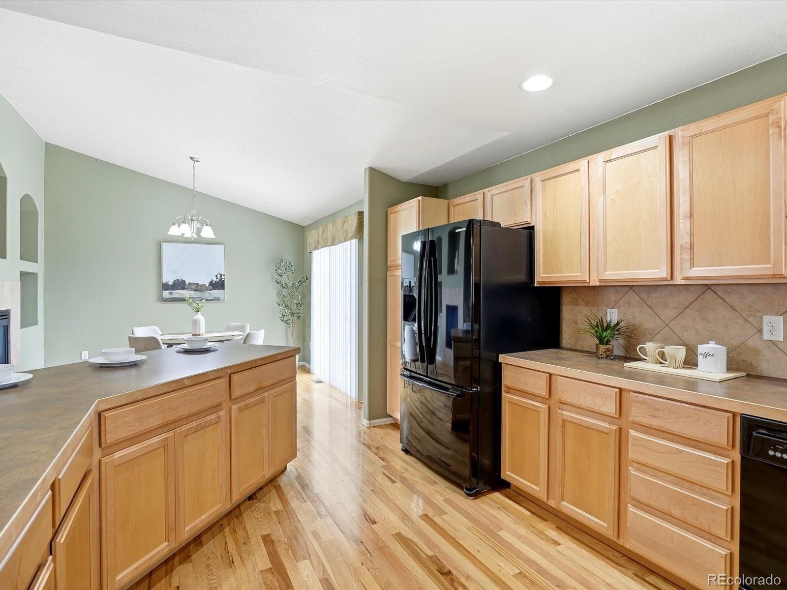 9720 Roadrunner Avenue Firestone, CO 80504 - Photo 13 of 46 a kitchen with a refrigerator sink and cabinets
