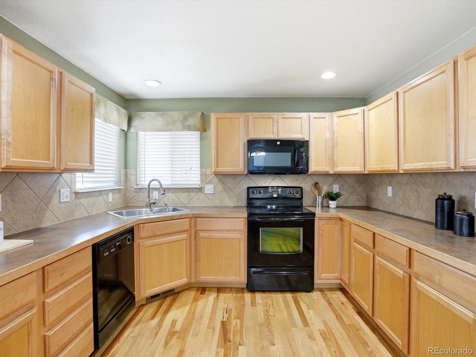9720 Roadrunner Avenue Firestone, CO 80504 - Photo 14 of 46 a kitchen with a sink a window stainless steel appliances and cabinets