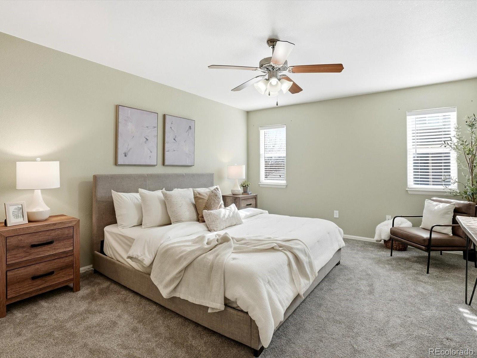 9720 Roadrunner Avenue Firestone, CO 80504 - Photo 15 of 46 a bedroom with a bed and a chandelier