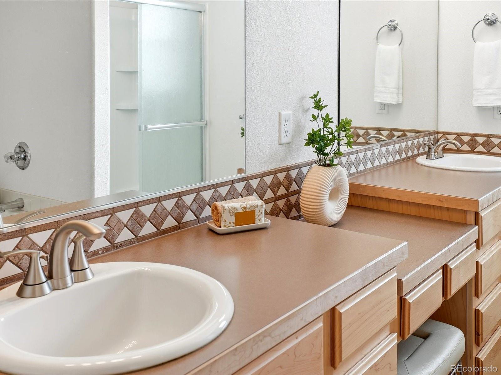 9720 Roadrunner Avenue Firestone, CO 80504 - Photo 19 of 46 a bathroom with a granite countertop sink and a mirror