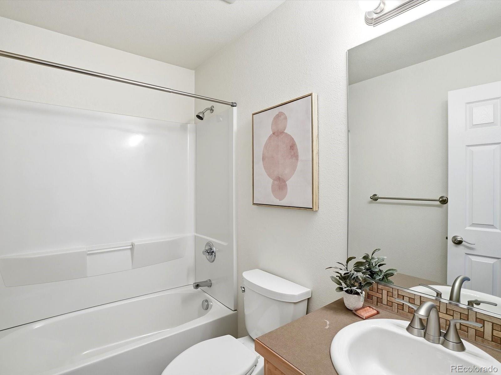 9720 Roadrunner Avenue Firestone, CO 80504 - Photo 23 of 46 a bathroom with a sink toilet and shower
