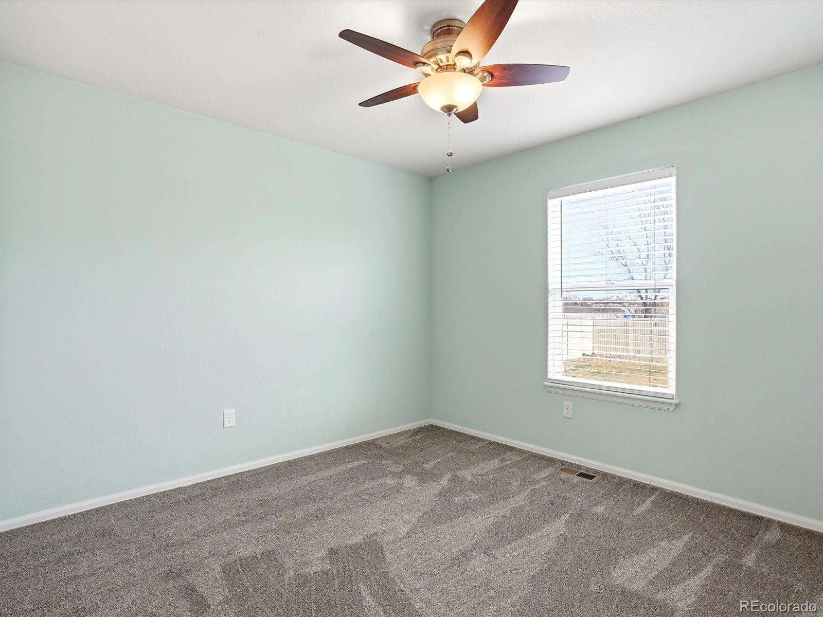 9720 Roadrunner Avenue Firestone, CO 80504 - Photo 24 of 46 an empty room with a window and a fan