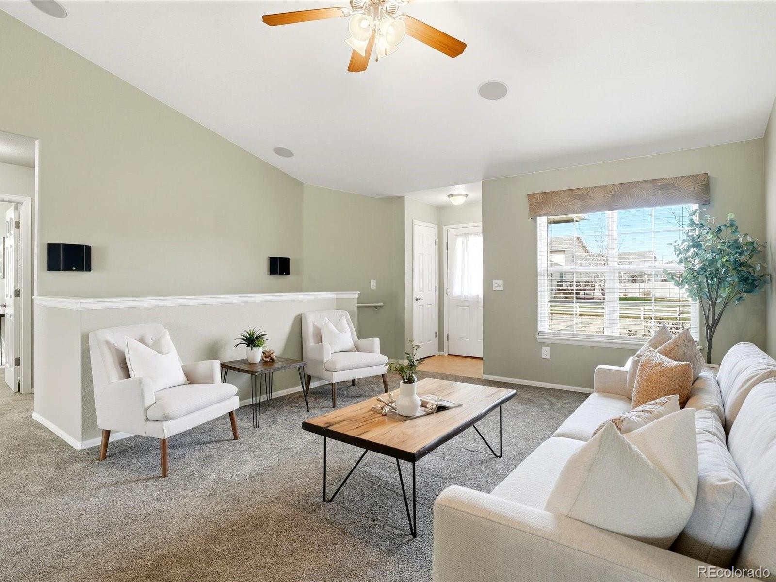9720 Roadrunner Avenue Firestone, CO 80504 - Photo 6 of 46 a living room with furniture and a large window
