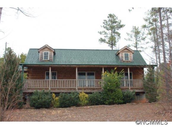 60 Rock Ridge Dr Mill Spring Mill Spring, NC 28756 - Photo 1 of 12 a front view of a house with a garden
