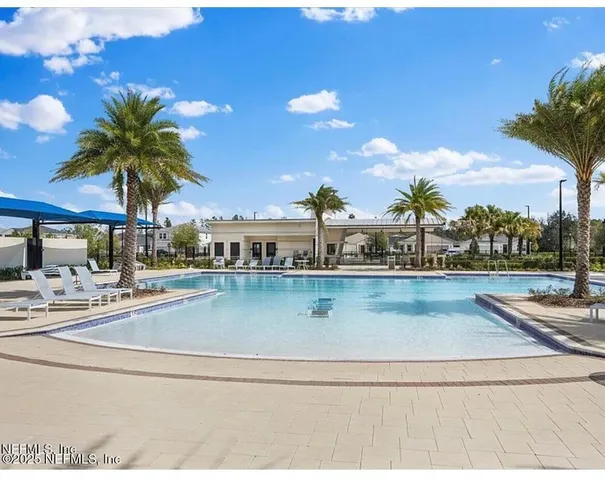 a view of swimming pool with outdoor seating