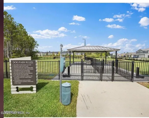 a view of a balcony with a floor to ceiling window and wooden fence
