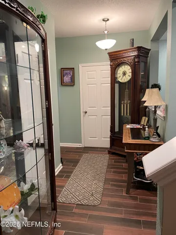 a view of living room with furniture and a mirror