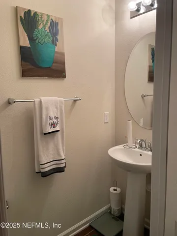 a bathroom with a sink mirror and toilet