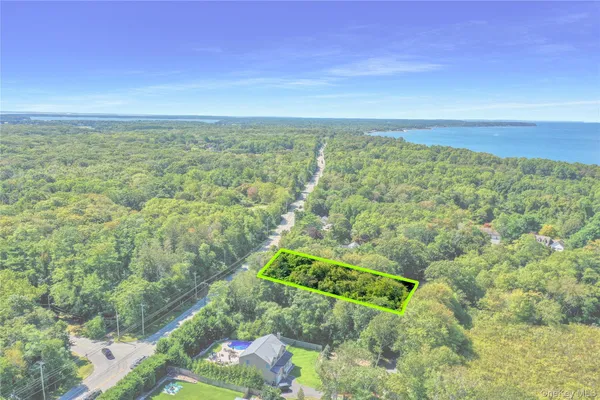 an aerial view of a houses with a yard