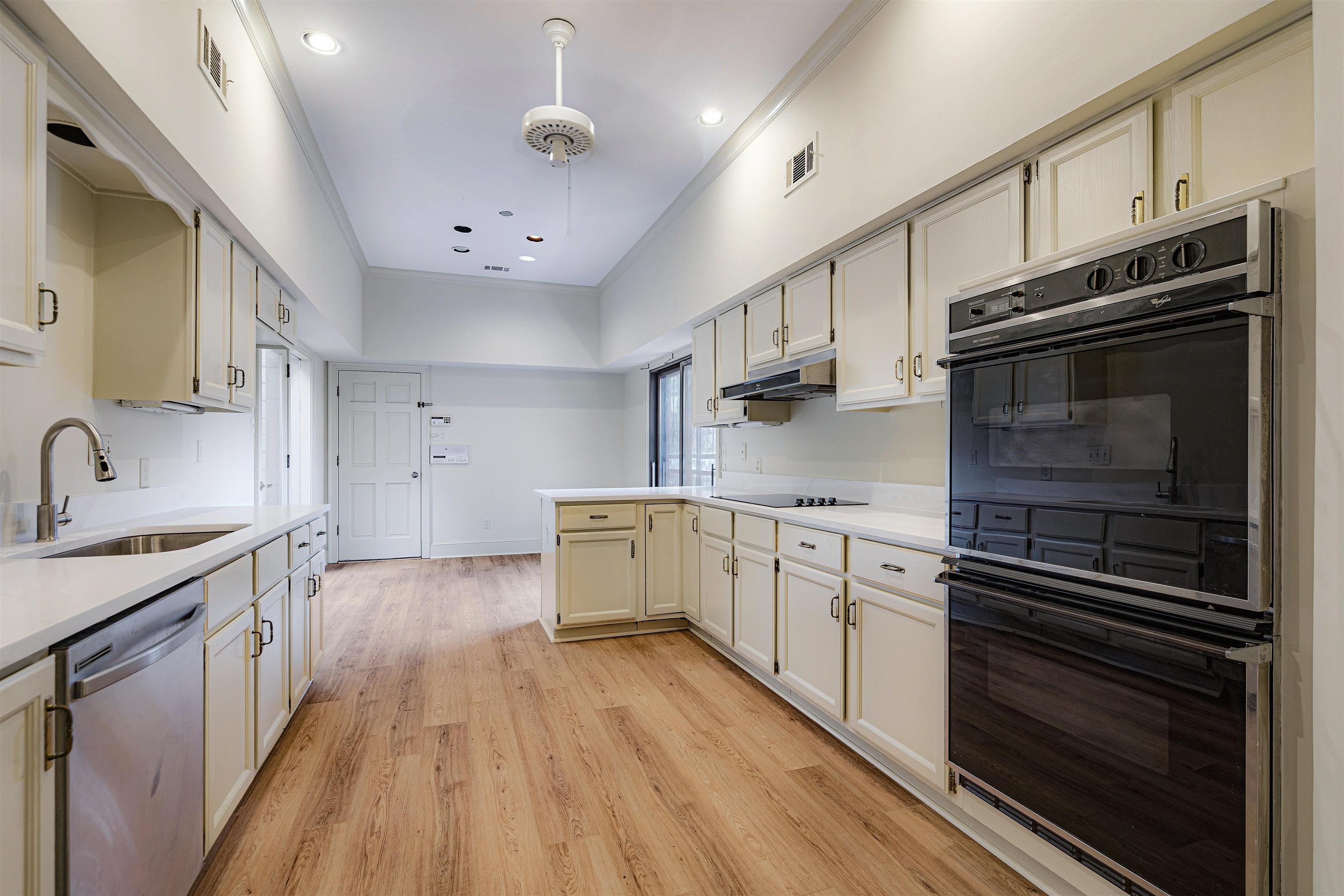 478 West Racquet Club Place Memphis, TN 38117 - Photo 12 of 39 a kitchen with stainless steel appliances a stove sink and cabinets