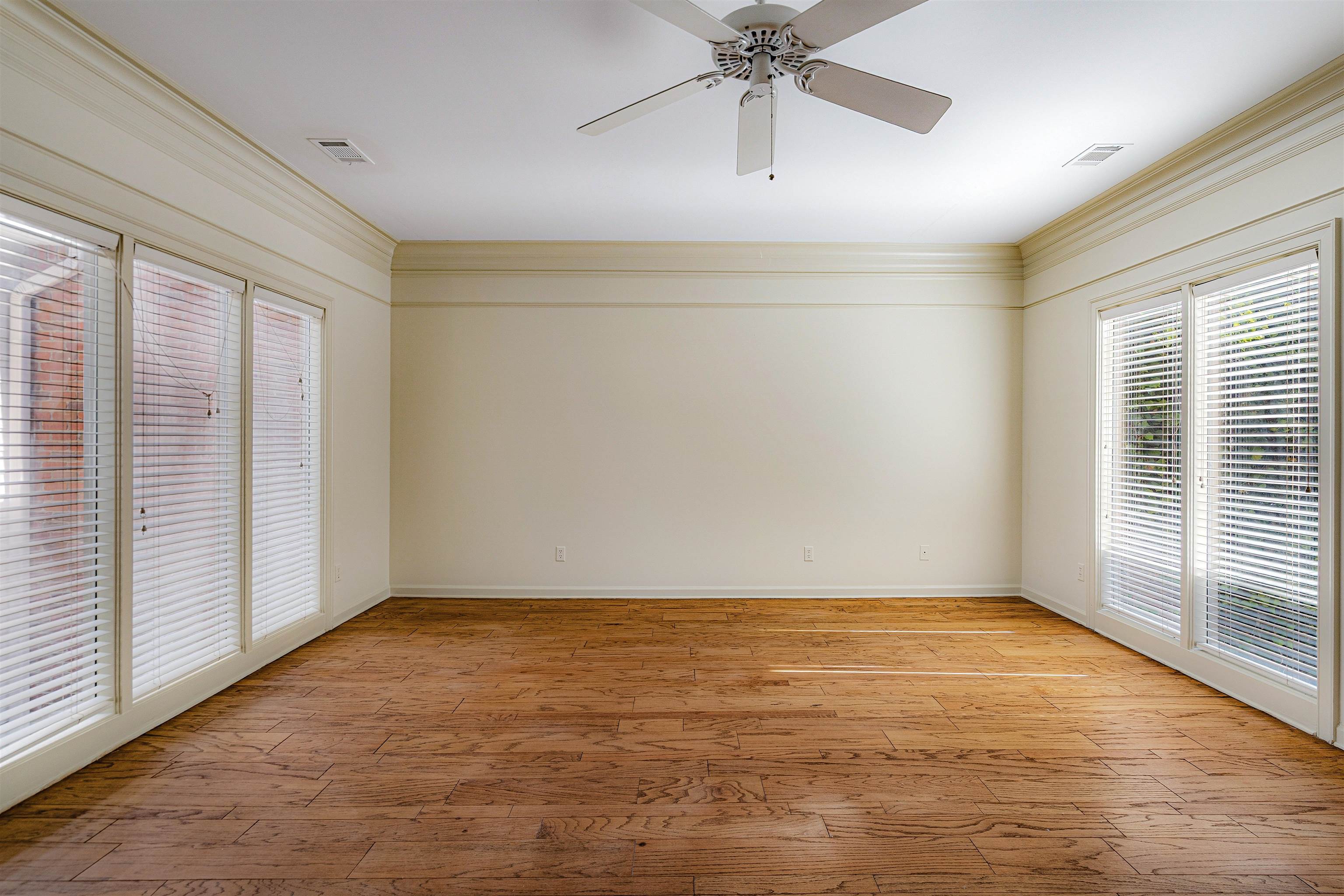 478 West Racquet Club Place Memphis, TN 38117 - Photo 20 of 39 a view of an empty room with a window and wooden floor