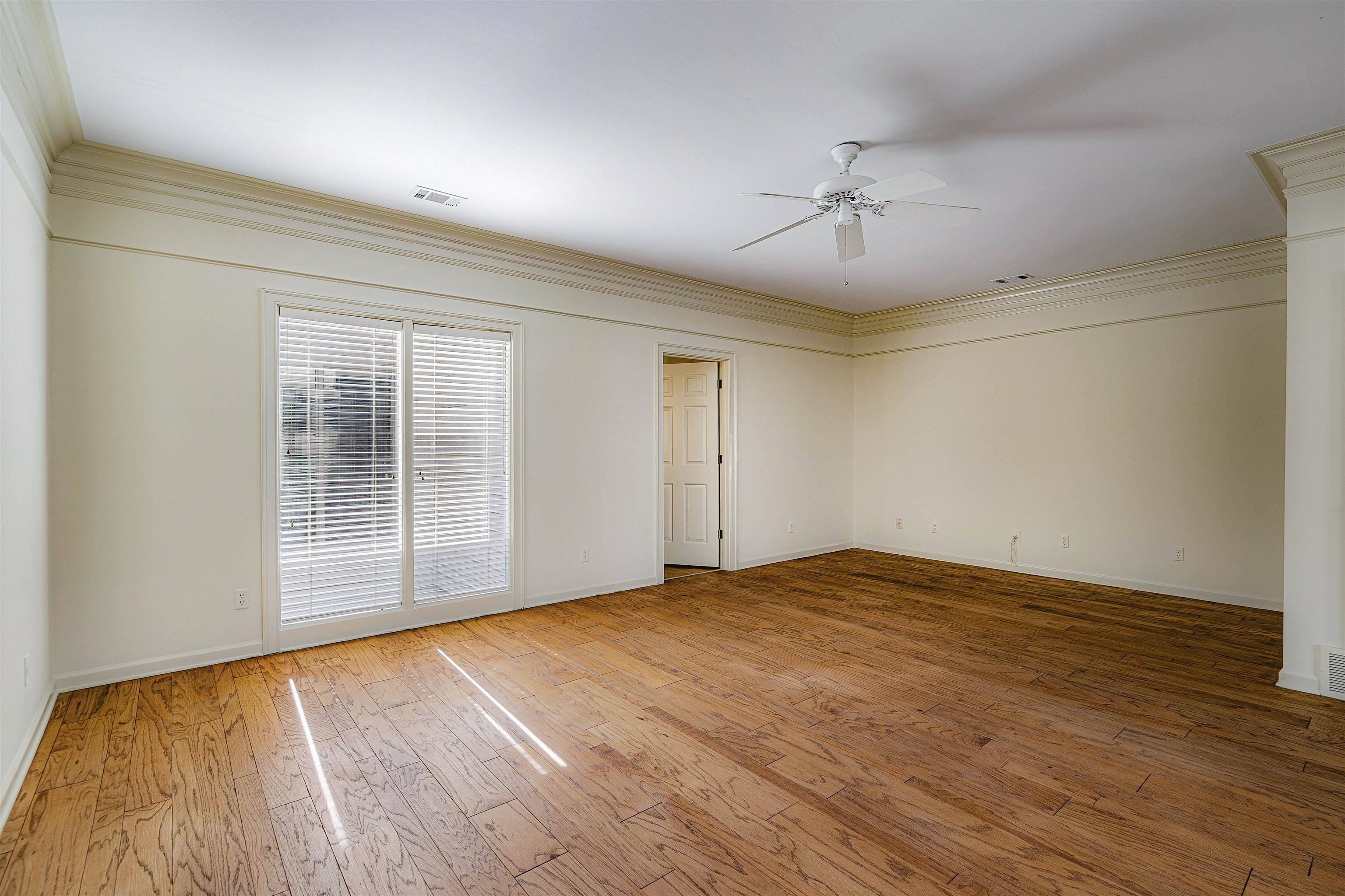 478 West Racquet Club Place Memphis, TN 38117 - Photo 21 of 39 a view of an empty room with wooden floor and a window