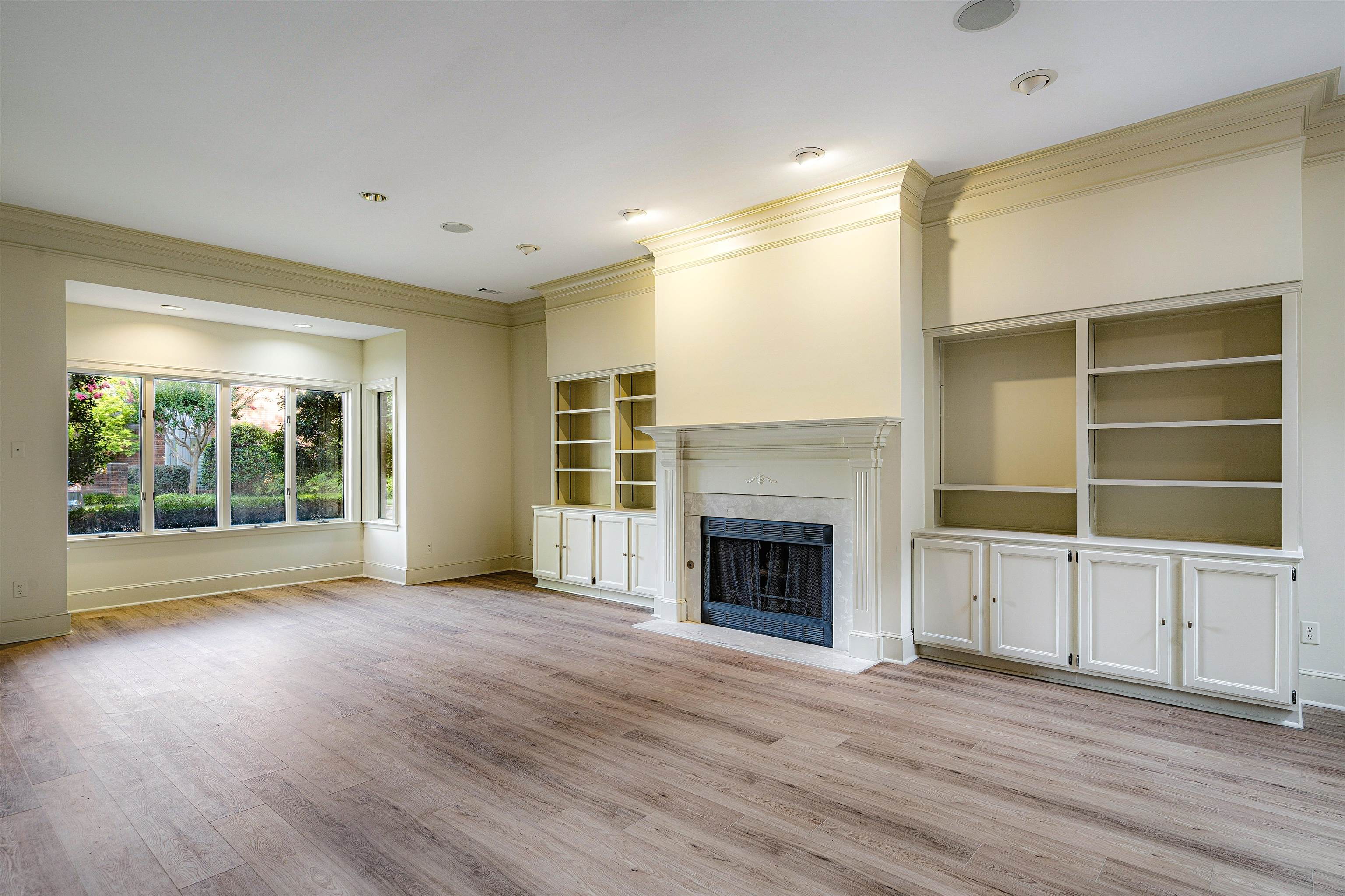 478 West Racquet Club Place Memphis, TN 38117 - Photo 7 of 39 a view of an empty room with a window and wooden floor