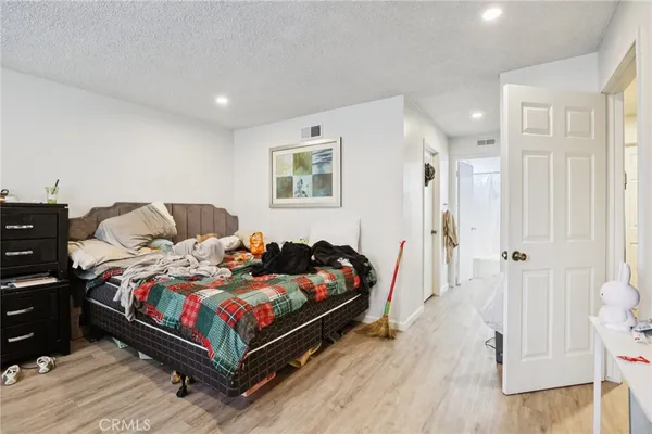 a bathroom with a granite countertop sink a mirror and shower