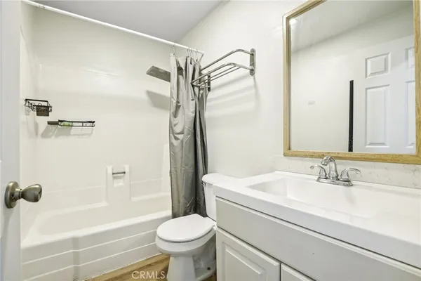 a bathroom with a sink mirror and shower
