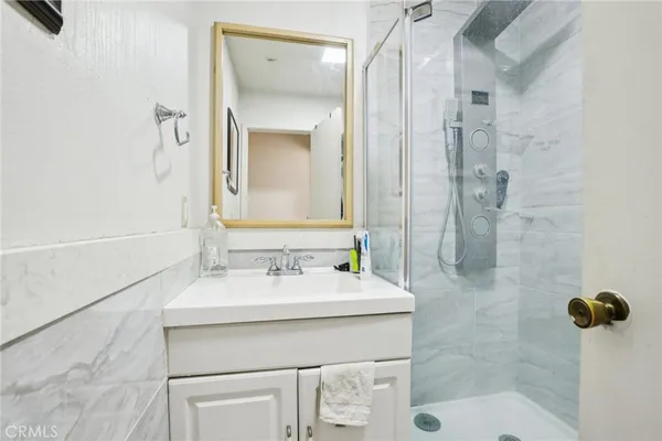 a bathroom with a sink toilet and shower