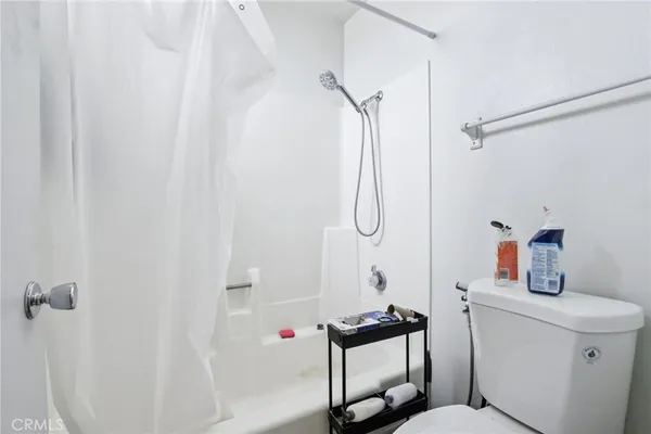 a view of bathroom with a sink mirror and cabinets