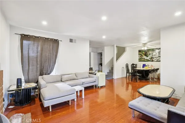 a living room with furniture a fireplace and large windows