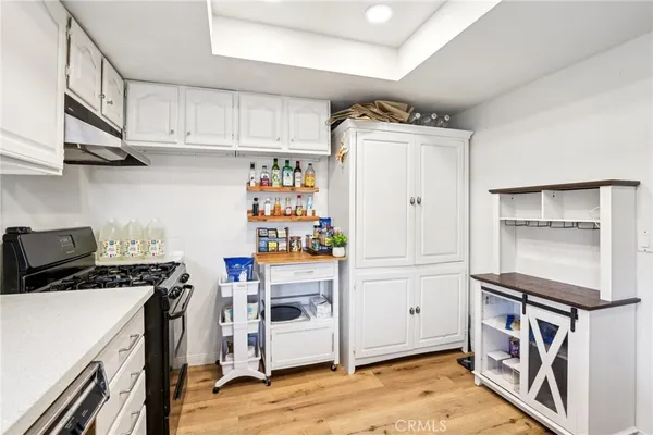 a kitchen with stainless steel appliances a stove a refrigerator and cabinets